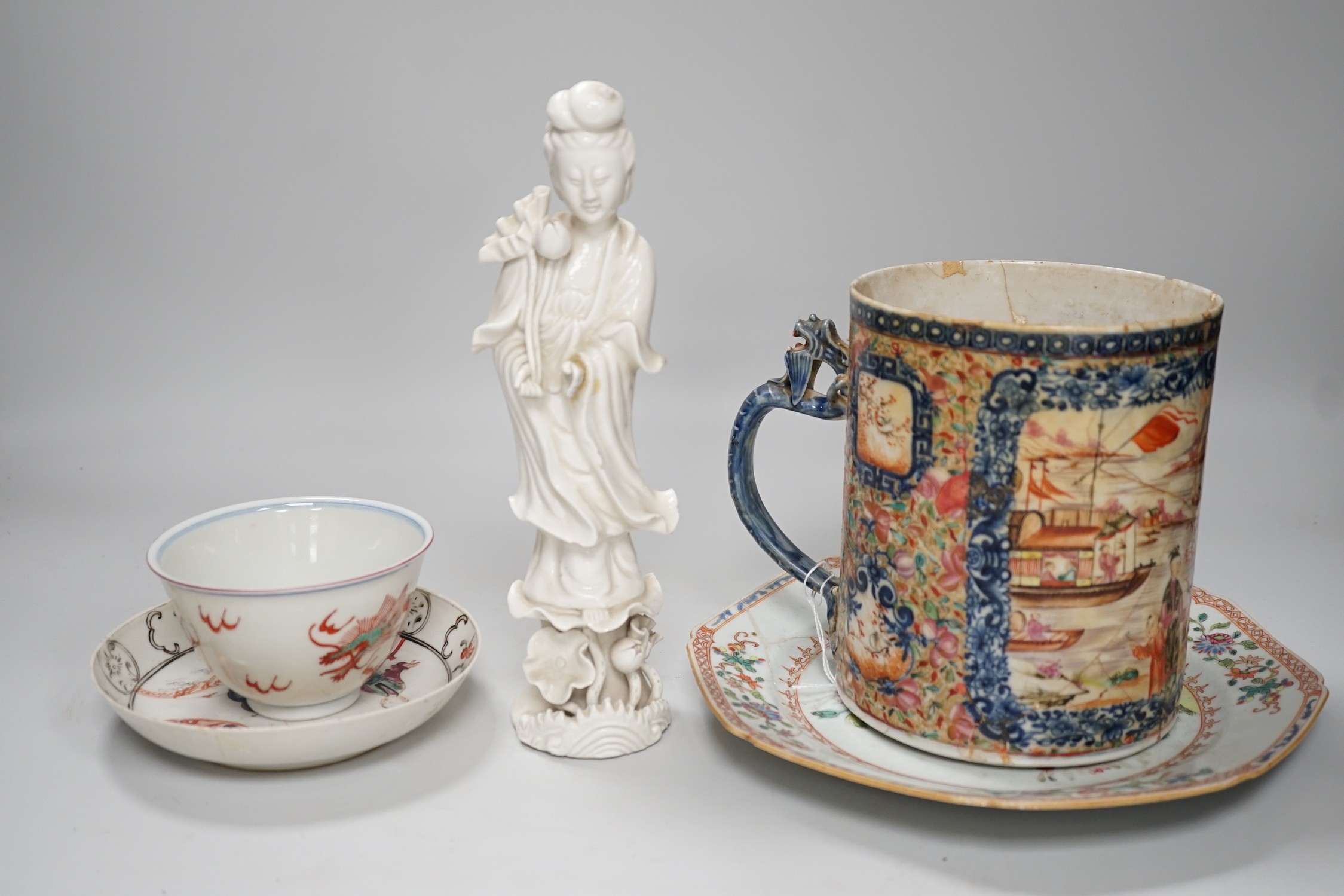 A Chinese figure of blanc de chine, a dragon tea bowl, a saucer, a large tankard, and another Chinese dish, tallest 23cm